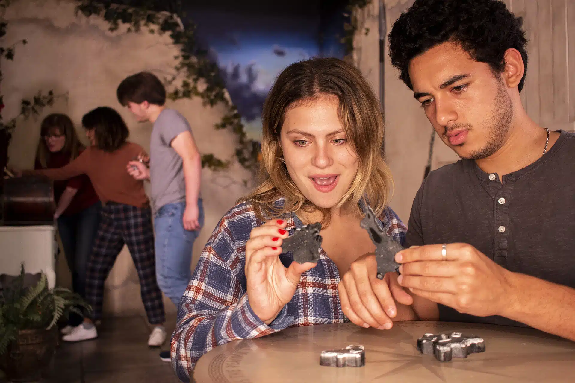 Players solving puzzles inside At Odds With The Gods.